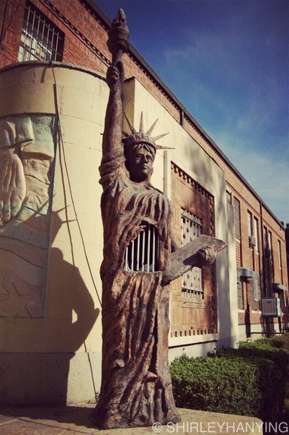 A replica of Statue of Liberty with a cage of doves inside it