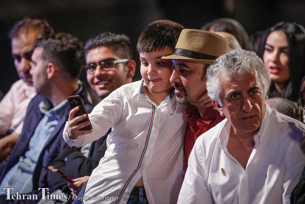 A kid taking a selfie with actor Reza Attaran attends the Iran Cinema Celebration in Tehran’s Mashq Square on September 12, 2016.