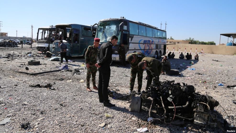 Iraqi security forces inspect the site of a blast where a suicide bomber detonated his explosives-laden ambulance in Iraq's holy city of Samarra, north of Baghdad, Nov. 6, 2016.