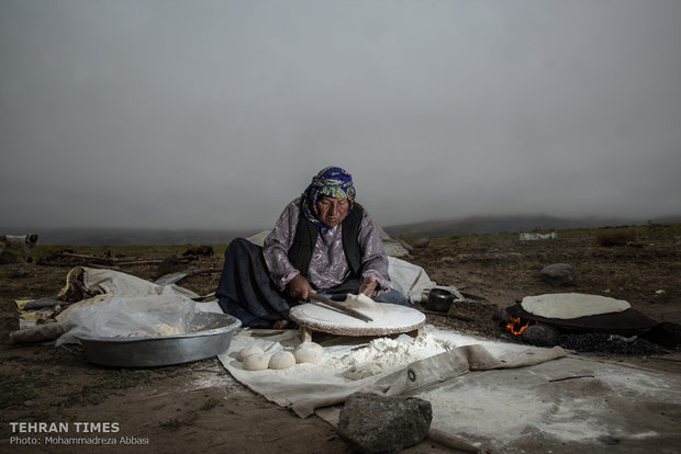Women bake fresh bread on a daily basis on a huge flat iron plate.