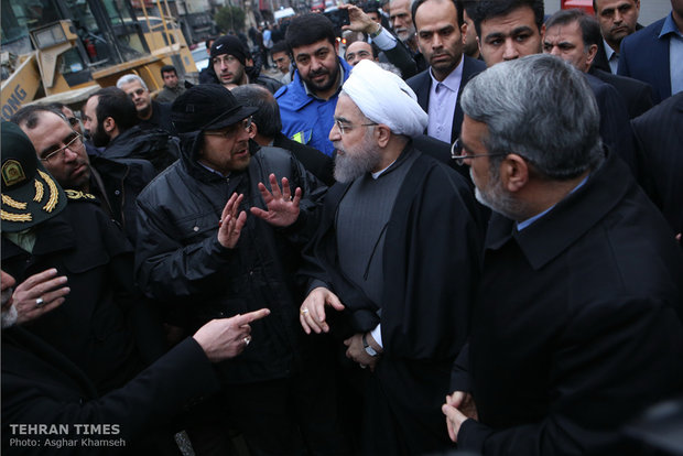 Rouhani visits building collapse site