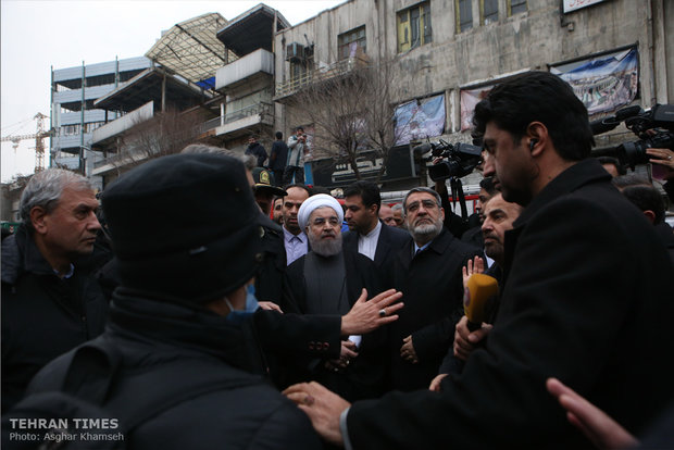 Rouhani visits building collapse site