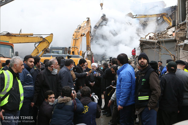 Rouhani visits building collapse site