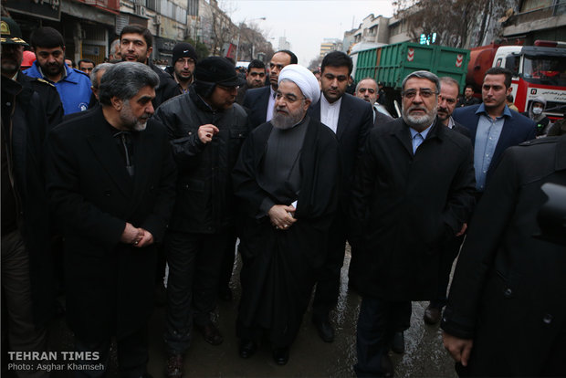 Rouhani visits building collapse site