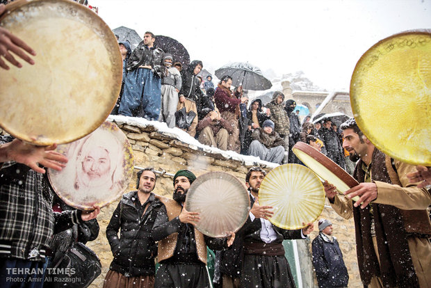  A group of villagers play daf while another group dance.  