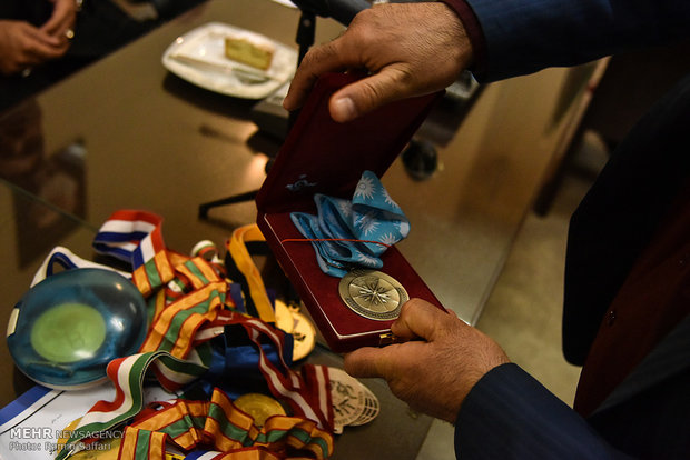 Former wrestling champ. bestows medals to Imam Reza museum