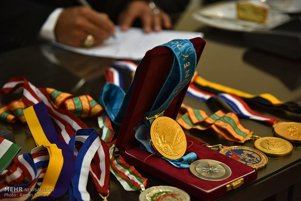 Former wrestling champ. bestows medals to Imam Reza museum