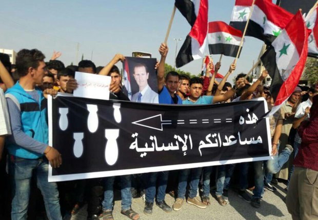 Protest in al-Sfeira condemning US-led coalition’s massacres against civilians