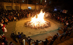 An undated photo depicts Iranian Zoroastrians encircling a huge open fire while celebrate their time-honored Sadeh festival in Tehran.