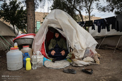 An old woman sitting in a tent in Kermanshah province