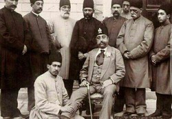 A man gives Mozaffar ad-Din Shah a foot massage as a number of the country’s officials are also seen in the photo.