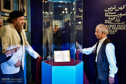 Cultural activist Ahmad Mohit-Tabatabai (L) and filmmaker Mohammadreza Aslani unveil Iran’s oldest film document ever found at the Film Museum of Iran on May 9, 2018. (Mehr/Behnam Tofiqi)