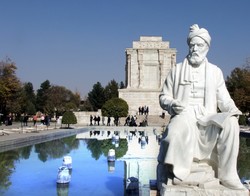 A view of Ferdowsi mausoleum with a statue of the Persian poet in the foreground
