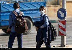 A school boy in Tehran is wearing a face mask to protect himself against air pollution