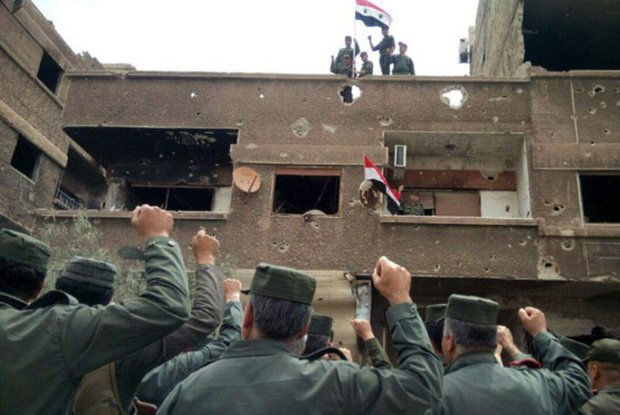 Intl. security forces hoist national flag over al-Hajar al-Aswad,al-Yarmouk Camp