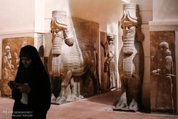 An undated photo depicts a woman visiting a Louvre show at the National Museum of Iran in downtown Tehran.