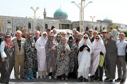  International travelers pose for a photo while visiting the holy shrine of Imam Reza (AS) in Mashhad, northeastern Iran. Women are clad in chadors, shapeless gowns that cover their entire bodies, to respect a dress code required for female pilgrims.