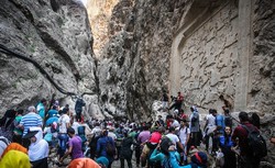 People revel in Tangeh Vashi near Firuzkuh, north-east Tehran province. The popular tourist resort features a Qajar-era bas-relief as well.