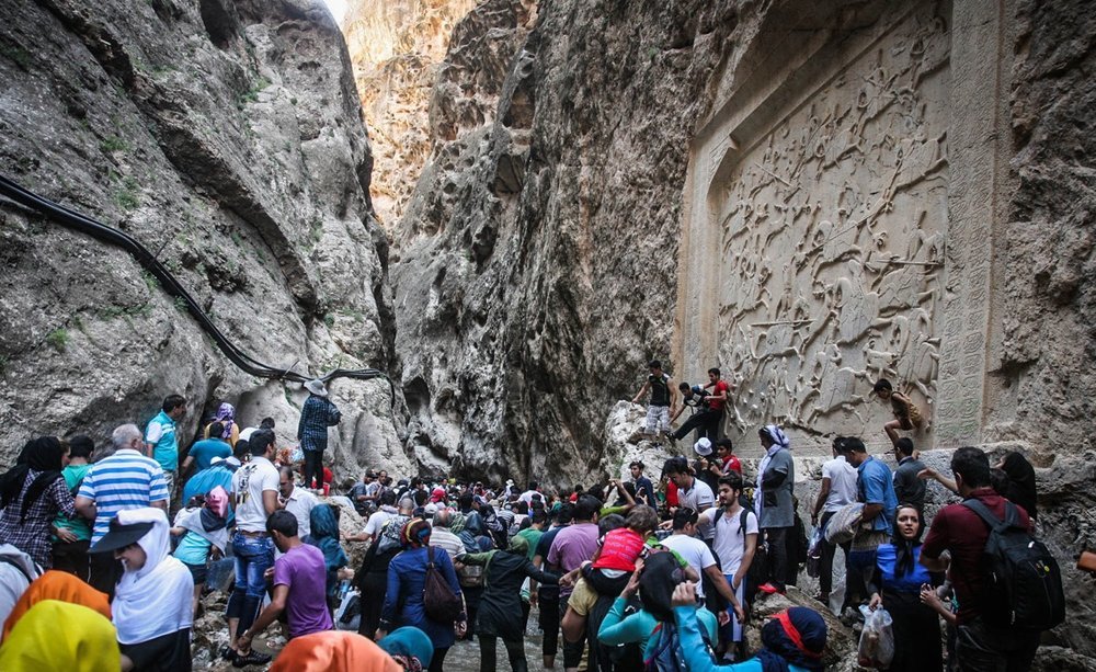 People revel in Tangeh Vashi near Firuzkuh, north-east Tehran province. The popular tourist resort features a Qajar-era bas-relief as well.