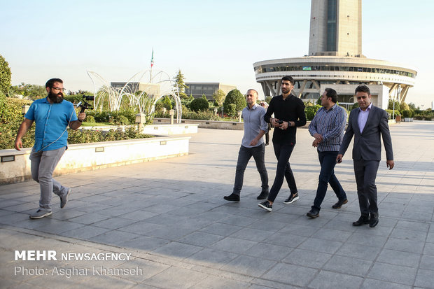 Iran's goal keeper watches World Cup final with teen workers