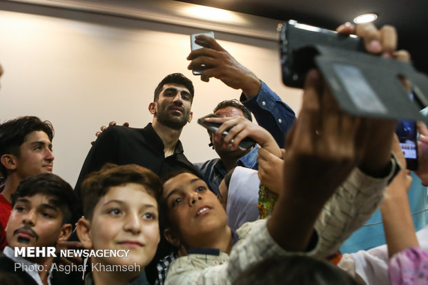 Iran's goal keeper watches World Cup final with teen workers