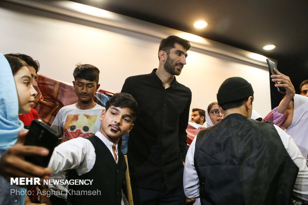Iran's goal keeper watches World Cup final with teen workers