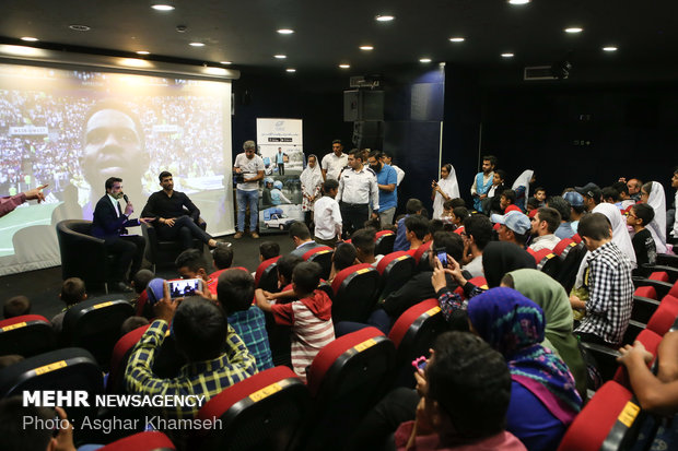 Iran's goal keeper watches World Cup final with teen workers