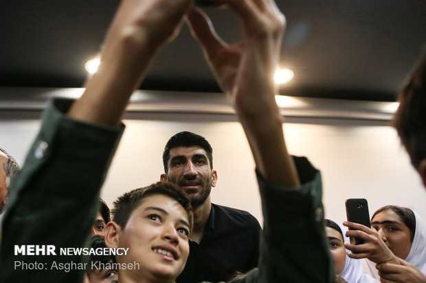 Iran's goal keeper watches World Cup final with teen workers