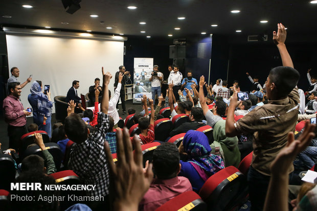 Iran's goal keeper watches World Cup final with teen workers