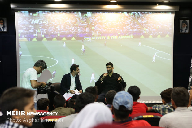 Iran's goal keeper watches World Cup final with teen workers