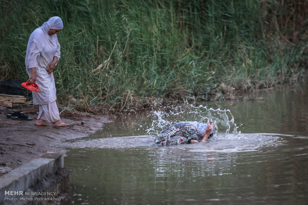 Mandaeans performing baptism in Karun River