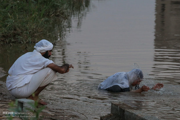 Mandaeans performing baptism in Karun River