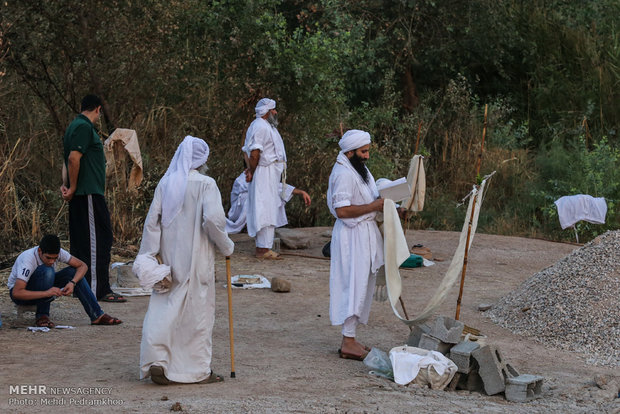 Mandaeans performing baptism in Karun River