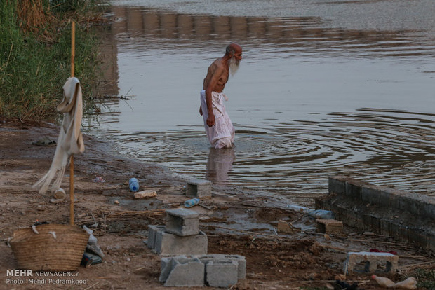 Mandaeans performing baptism in Karun River