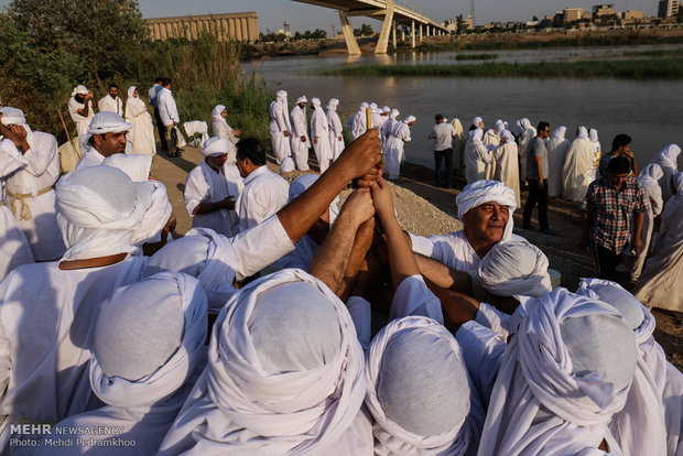 Mandaeans performing baptism in Karun River