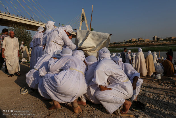 Mandaeans performing baptism in Karun River