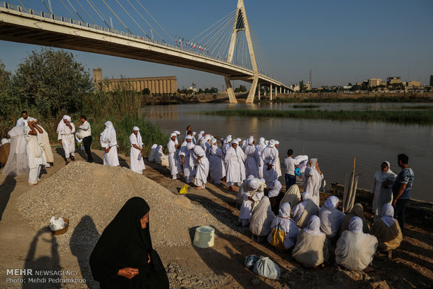 Mandaeans performing baptism in Karun River