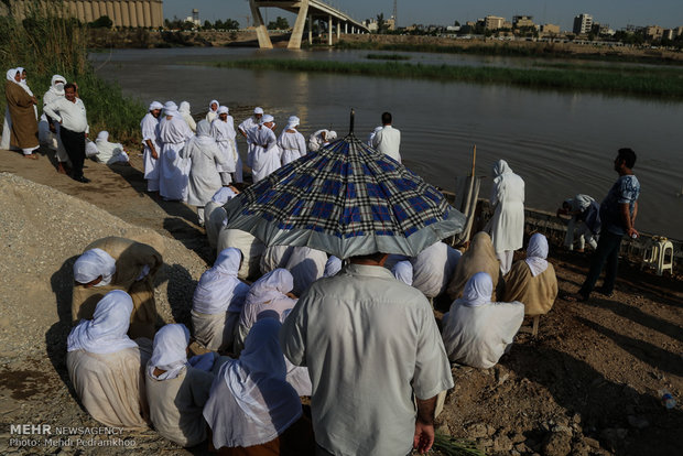 Mandaeans performing baptism in Karun River