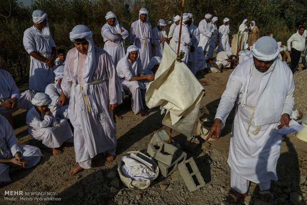 Mandaeans performing baptism in Karun River