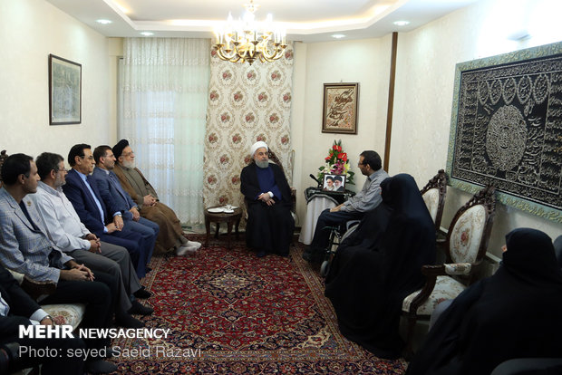 President Rouhani visits a war veteran