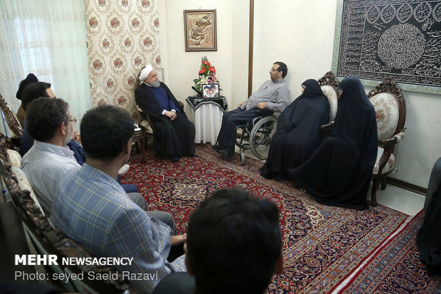 President Rouhani visits a war veteran