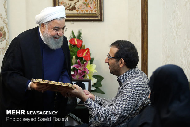 President Rouhani visits a war veteran