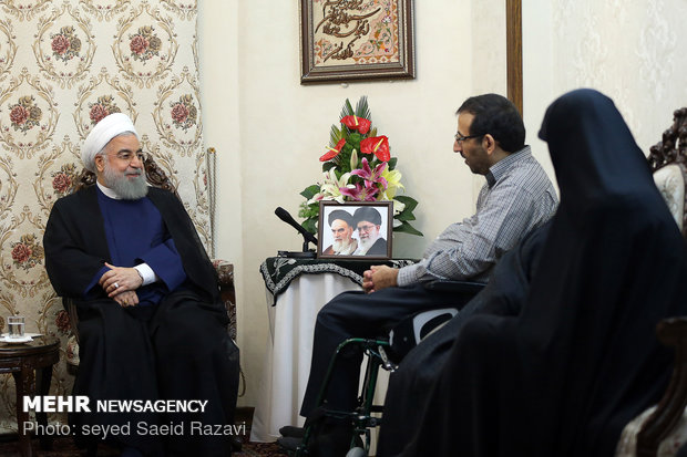 President Rouhani visits a war veteran