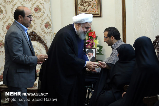 President Rouhani visits a war veteran