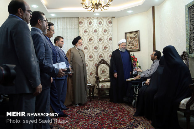 President Rouhani visits a war veteran