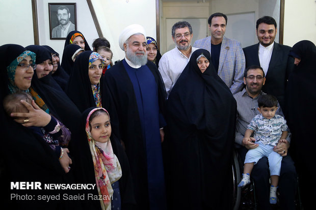 President Rouhani visits a war veteran