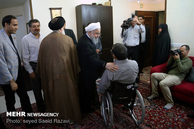 President Rouhani visits a war veteran