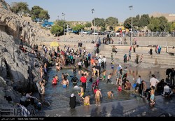 People swim in a natural pool in Cheshmeh-Ali, a historical site in southern Tehran, July 1, 2017.