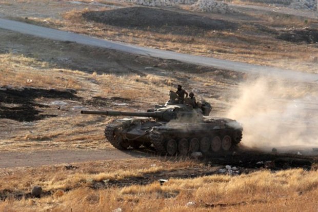 Armed groups in Syria's southwest surrender tanks, howitzers