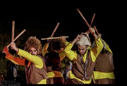 Natives of Mazandaran province wave sticks while performing a traditional dance at the foot of Tehran’s Milad Tower, August 3, 2018.